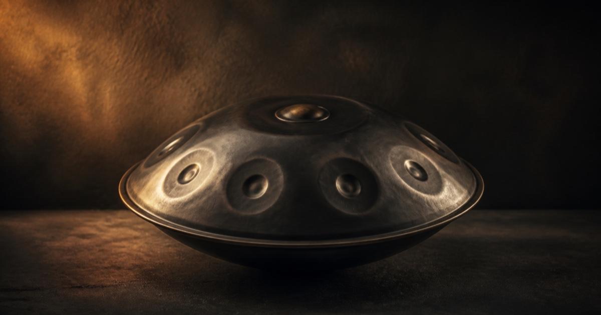 Handcrafted handpan in a warm, dark studio setting