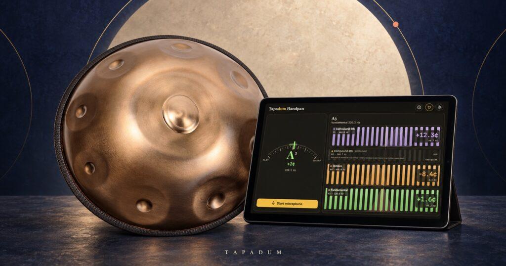 Bronze handpan beside a tablet showing the Tapadum Handpan Tuner and its overtone analysis.